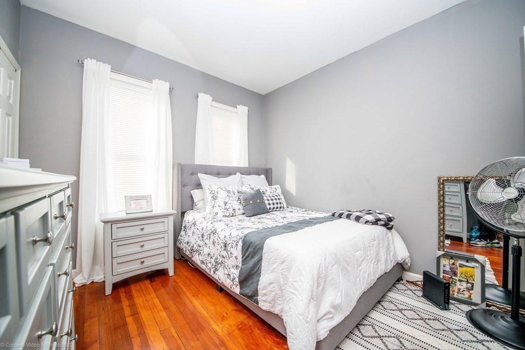 170 Buffinton Street Fall River, MA 02721 - Photo 13 of 38 a bedroom with a bed and wooden floor