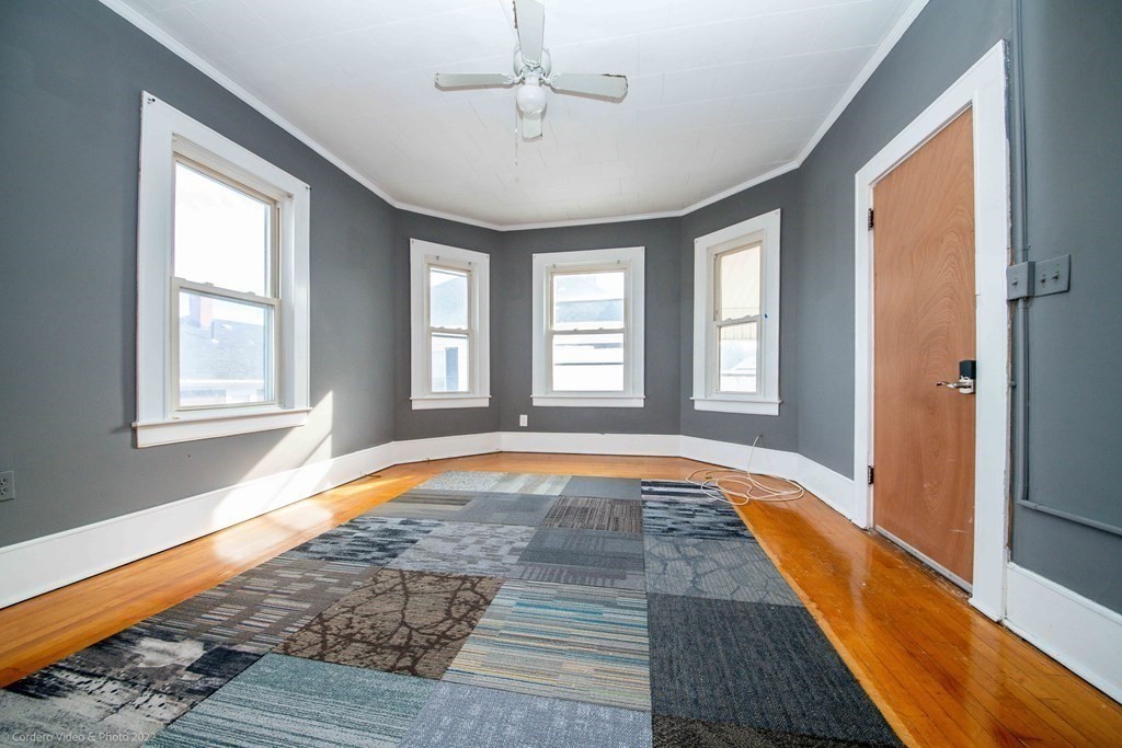 170 Buffinton Street Fall River, MA 02721 - Photo 14 of 38 a view of empty room with wooden floor and fan