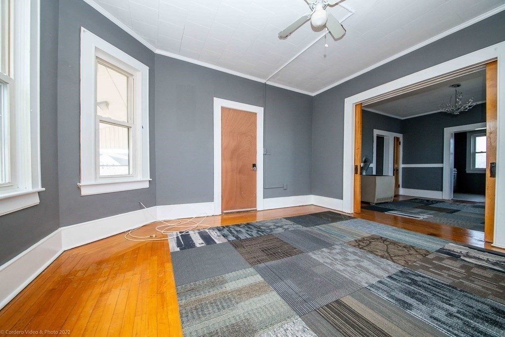 170 Buffinton Street Fall River, MA 02721 - Photo 16 of 38 a view of an empty room with wooden floor and a window