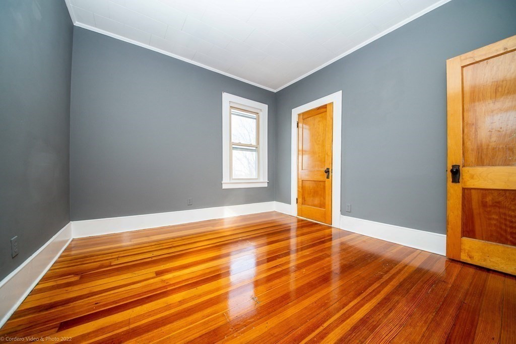170 Buffinton Street Fall River, MA 02721 - Photo 20 of 38 a view of an empty room with wooden floor and a window