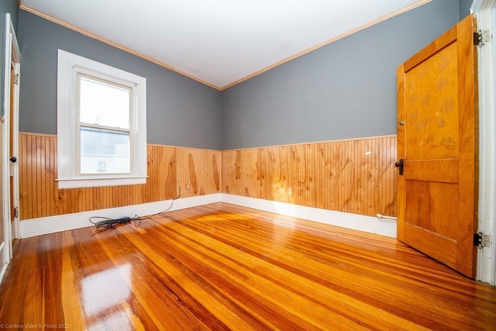 170 Buffinton Street Fall River, MA 02721 - Photo 21 of 38 a view of an empty room with wooden floor and a window