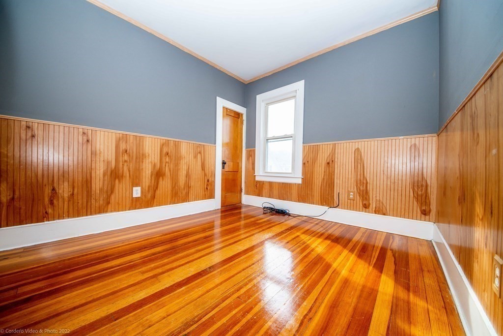 170 Buffinton Street Fall River, MA 02721 - Photo 22 of 38 a view of an empty room with wooden floor and a window