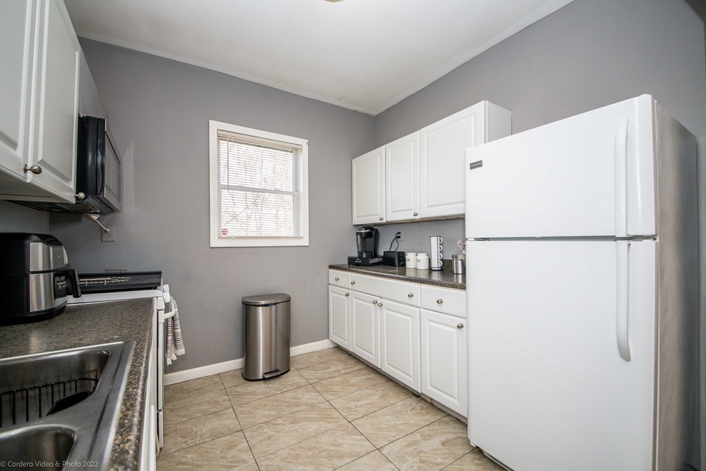 170 Buffinton Street Fall River, MA 02721 - Photo 8 of 38 a kitchen with stainless steel appliances granite countertop a refrigerator sink and stove