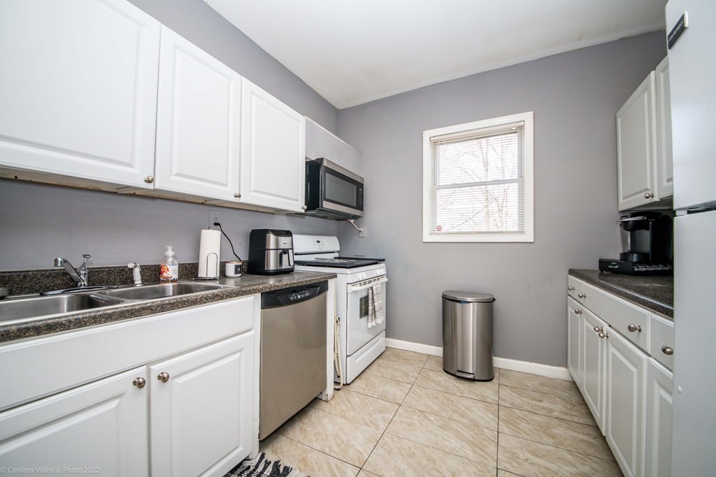 170 Buffinton Street Fall River, MA 02721 - Photo 9 of 38 a kitchen with stainless steel appliances granite countertop a sink stove and cabinets
