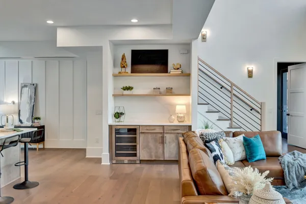 a spacious bedroom with a large bed and a chandelier