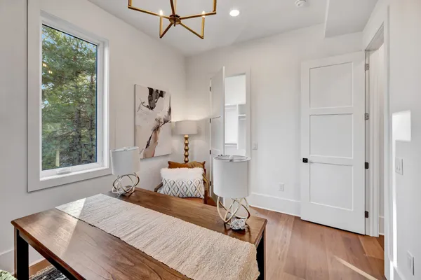 a living room with patio furniture and a floor to ceiling window