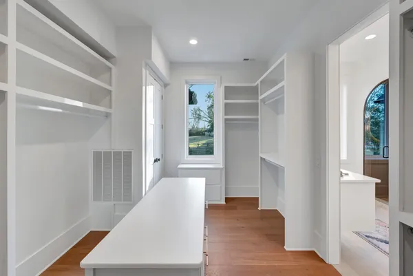 a view of walk in closet with empty racks