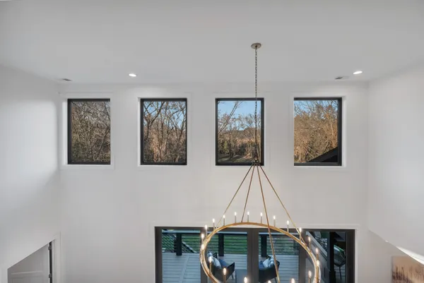 a view of backyard with barbeque grill and wooden fence