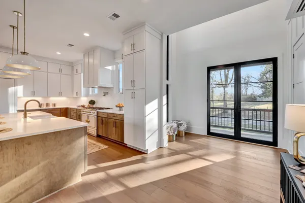a kitchen with stove and refrigerator