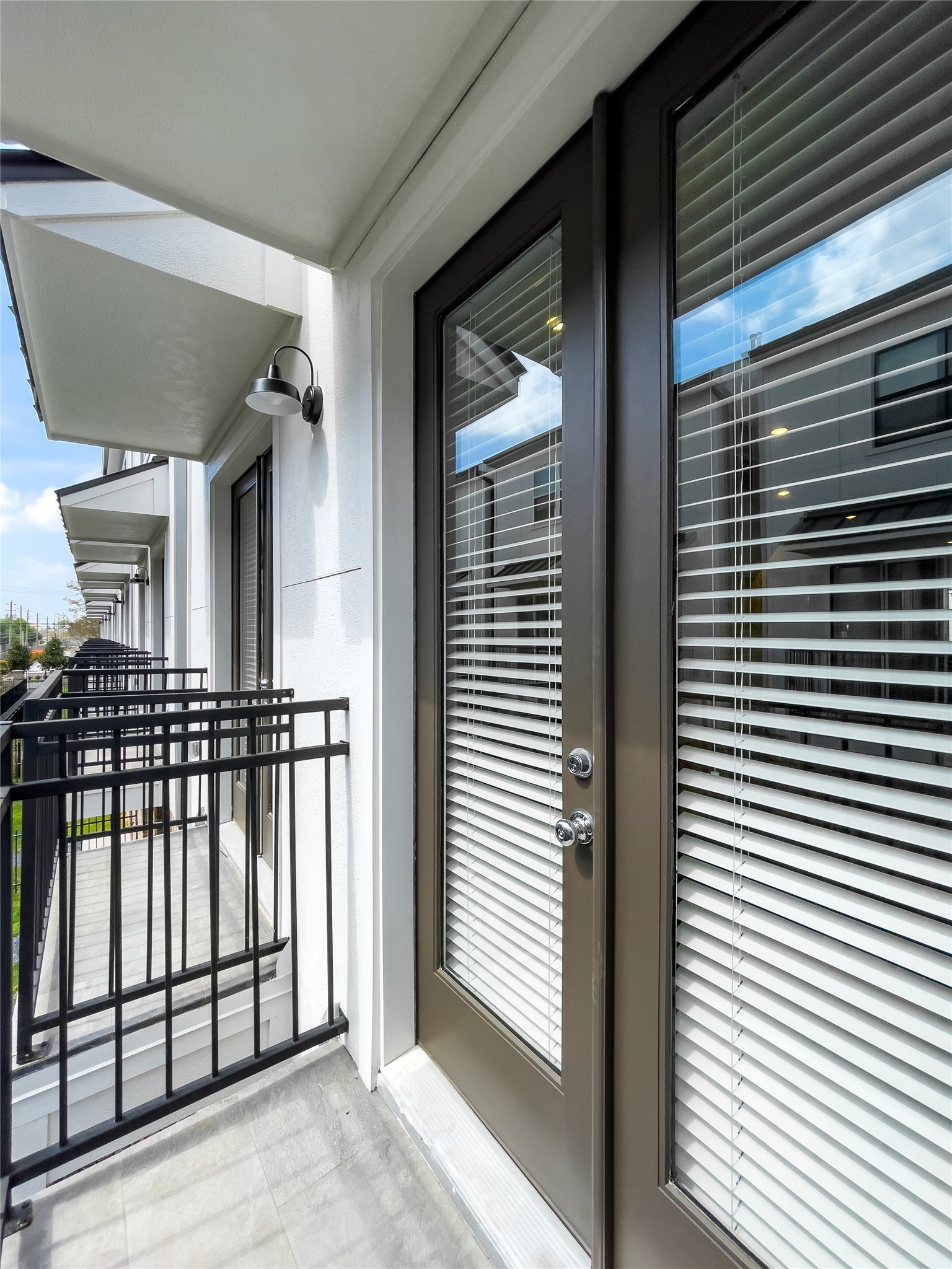 1250 North Post Oak Road, Unit C Houston, TX 77055 - Photo 26 of 31 Two charming Juliet balconies extend from the second-floor living room, enhancing the space with elegance and light.