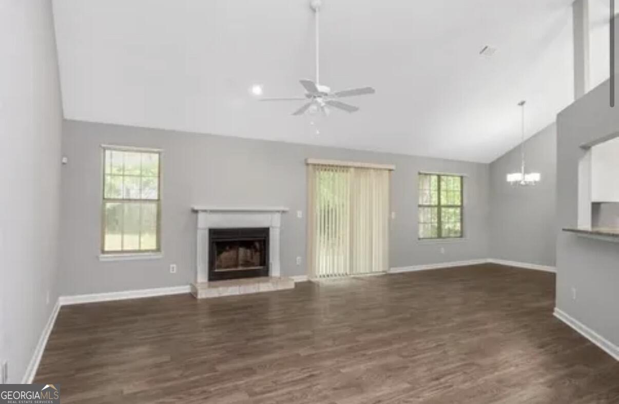 956 Forest Path Stone Mountain, GA 30088 - Photo 3 of 11 a view of an empty room with a window and fireplace