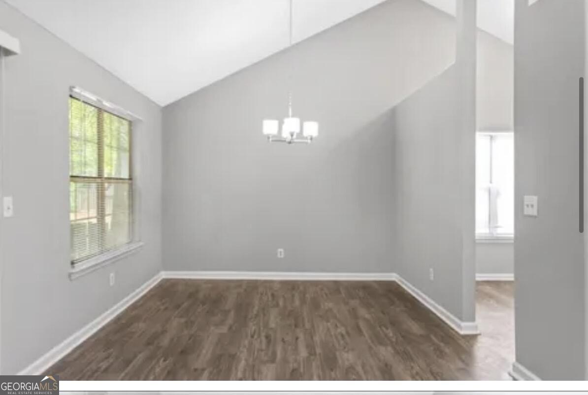 956 Forest Path Stone Mountain, GA 30088 - Photo 7 of 11 a view of empty room with wooden floor and fan