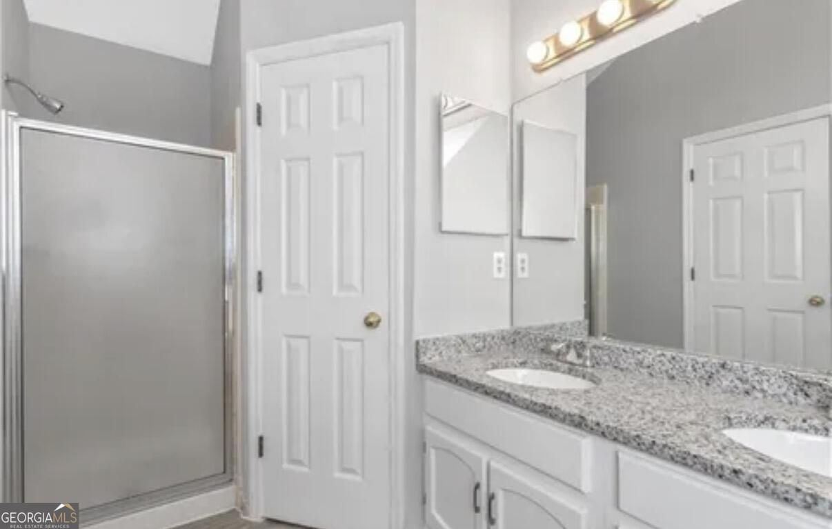 956 Forest Path Stone Mountain, GA 30088 - Photo 10 of 11 a bathroom with a granite countertop sink and a mirror