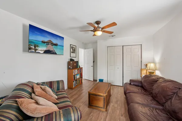 a living room with furniture fireplace and wooden floor