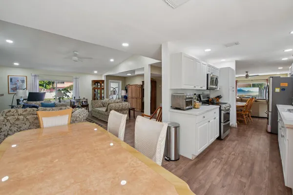 a kitchen with a sink cabinets and wooden floor