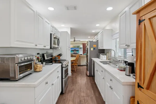 a kitchen with a stove and white cabinets