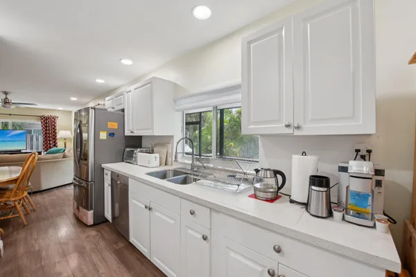 a kitchen with stainless steel appliances a sink a stove and cabinets