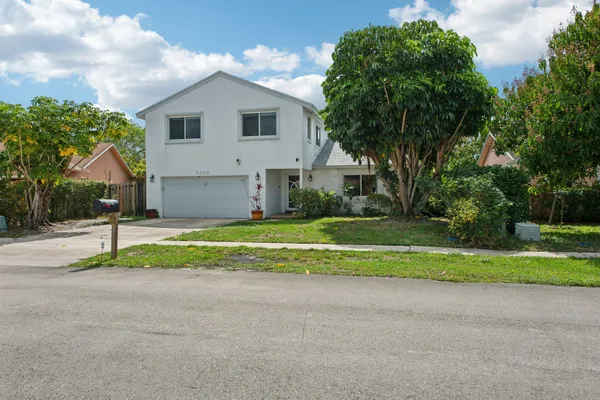 a front view of house with yard and green space