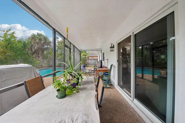 a backyard of a house with table and chairs