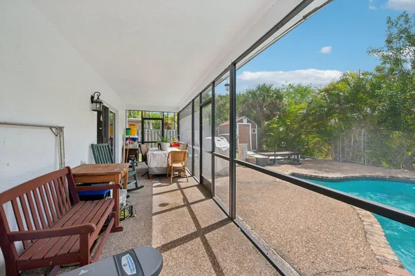 a view of a backyard with table and chairs and potted plants