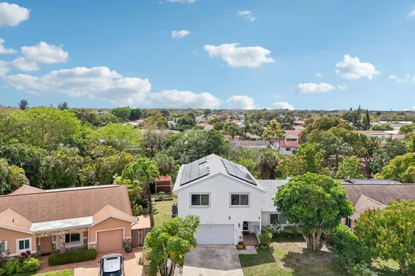 an aerial view of residential houses with outdoor space and swimming pool