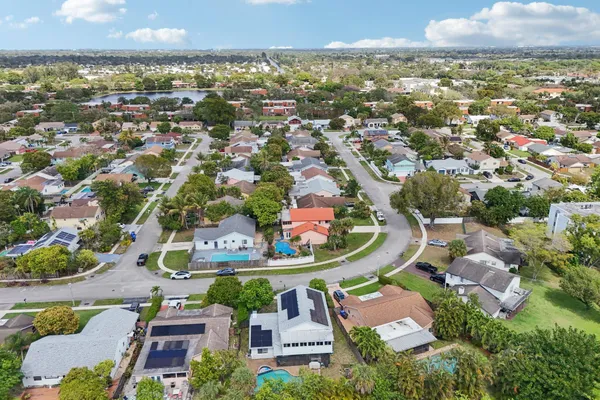 an aerial view of a house with yard swimming pool and outdoor seating