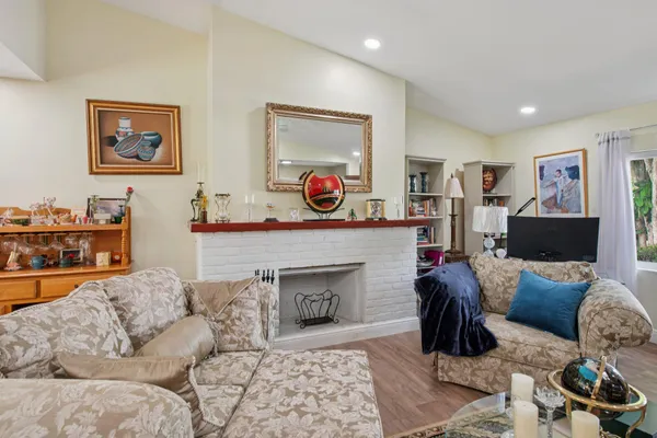 a living room with furniture and a floor to ceiling window