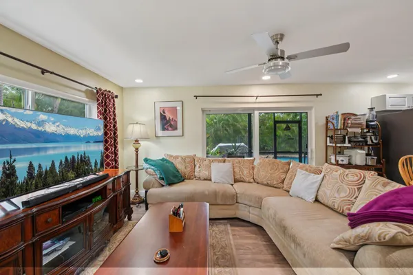 a living room with furniture ceiling fan and a rug