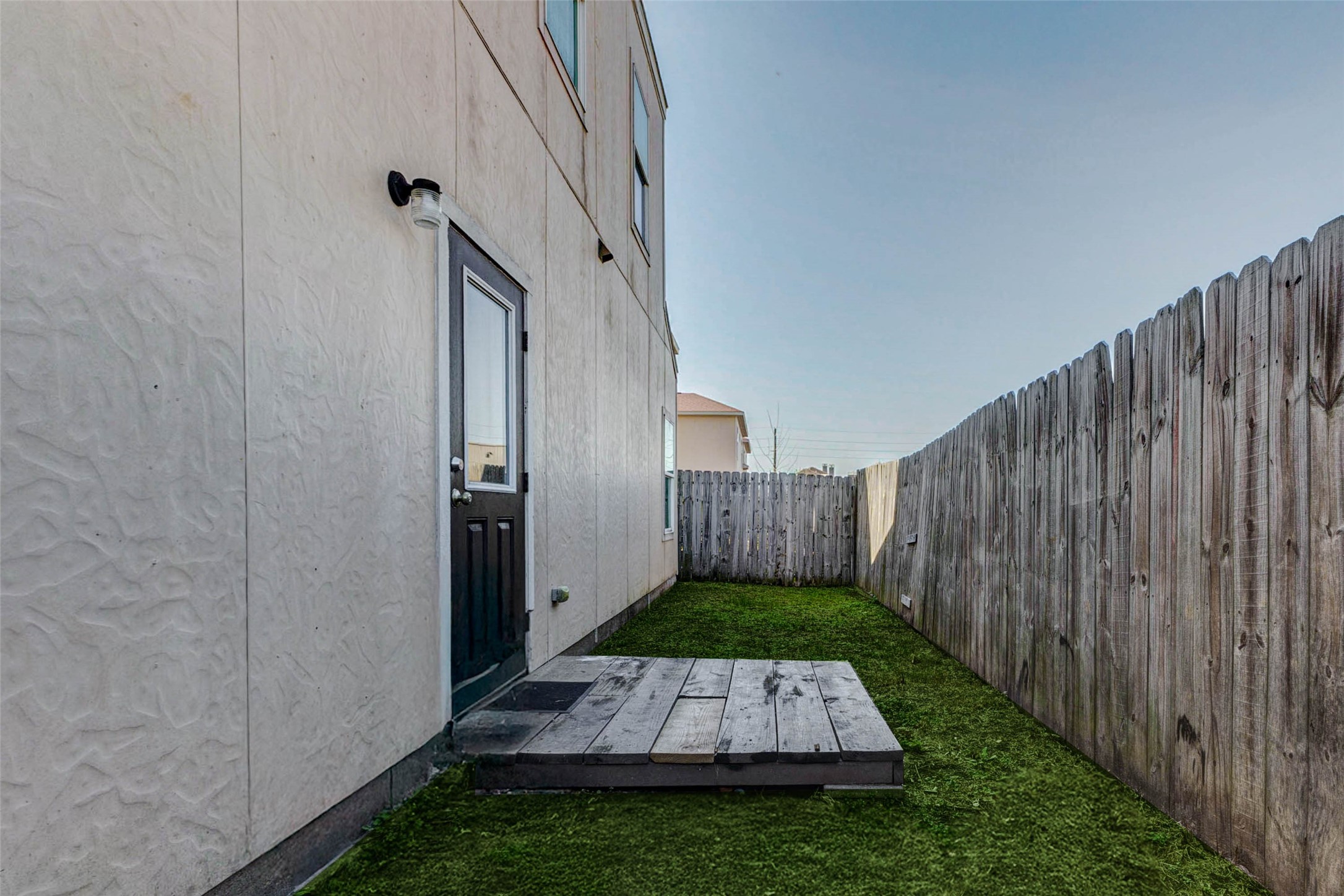 8622 Torcello Street Houston, TX 77031 - Photo 5 of 28 a view of backyard with potted plants and wooden fence