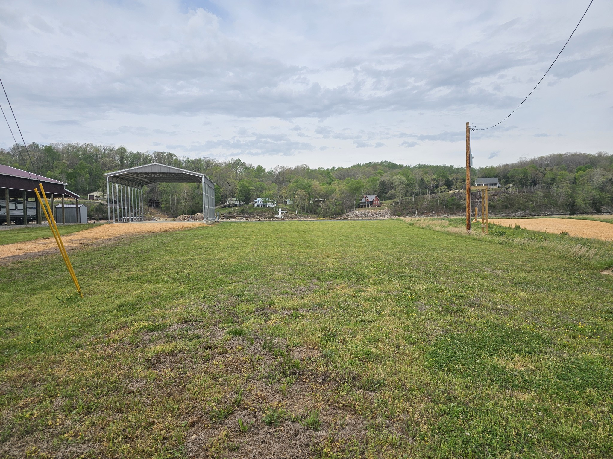 2027 Hardin Bottom River Road Clifton, TN 38425 - Photo 8 of 33 a backyard of a house with table and chairs