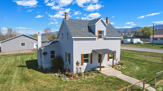 295 East 100 North Mount Pleasant, UT 84647 - Photo 1 of 1 View of home's Front with a mountain view, a chimney, and roof with shingles