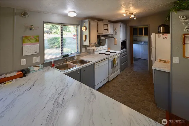a kitchen with refrigerator cabinets and wooden floor