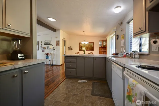 a kitchen with stainless steel appliances granite countertop a sink stove and cabinets