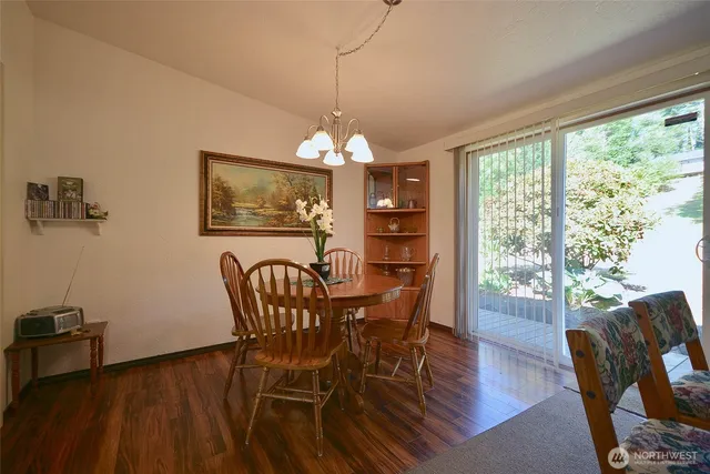 a dining room with furniture a window and wooden floor