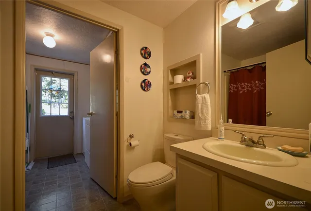a bathroom with a granite countertop sink toilet and shower