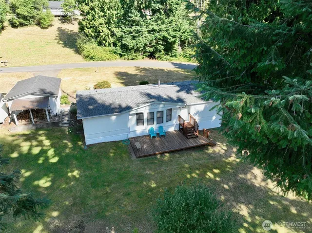 a view of a house with a yard porch and sitting area