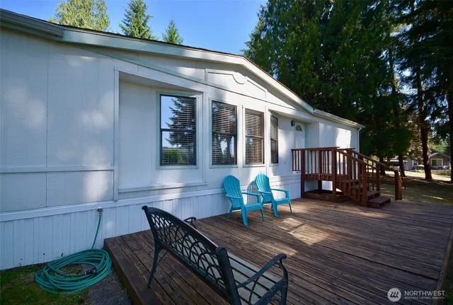 a view of a house with a chairs and table in patio