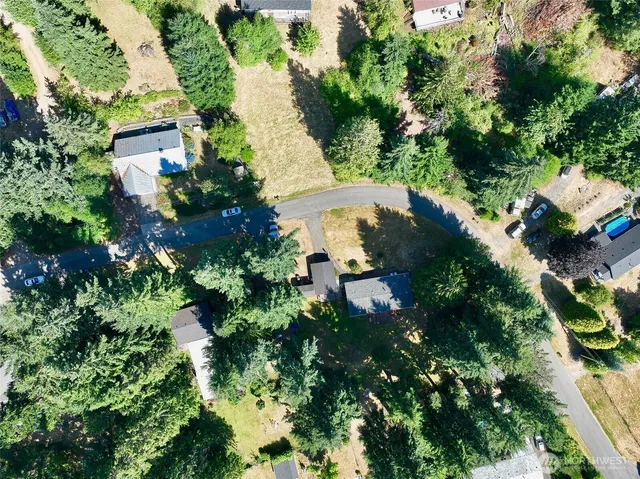 an aerial view of a house with a yard and lake view
