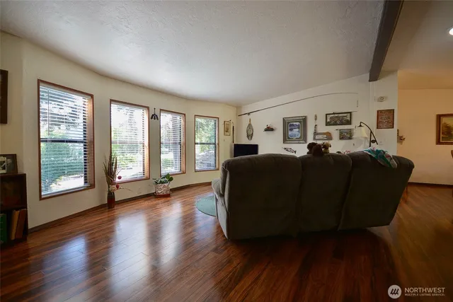 a living room with furniture and large windows