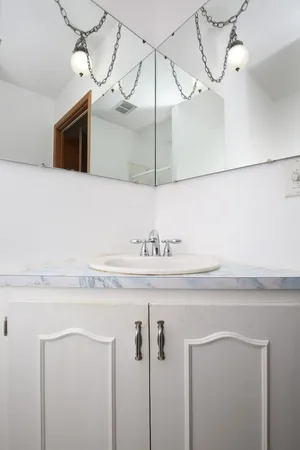 a bathroom with a sink a mirror and a shower