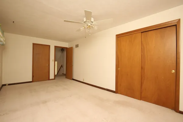 a view of an empty room with a closet