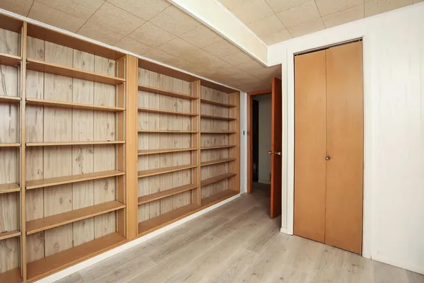 a view of room with wooden floor and closet