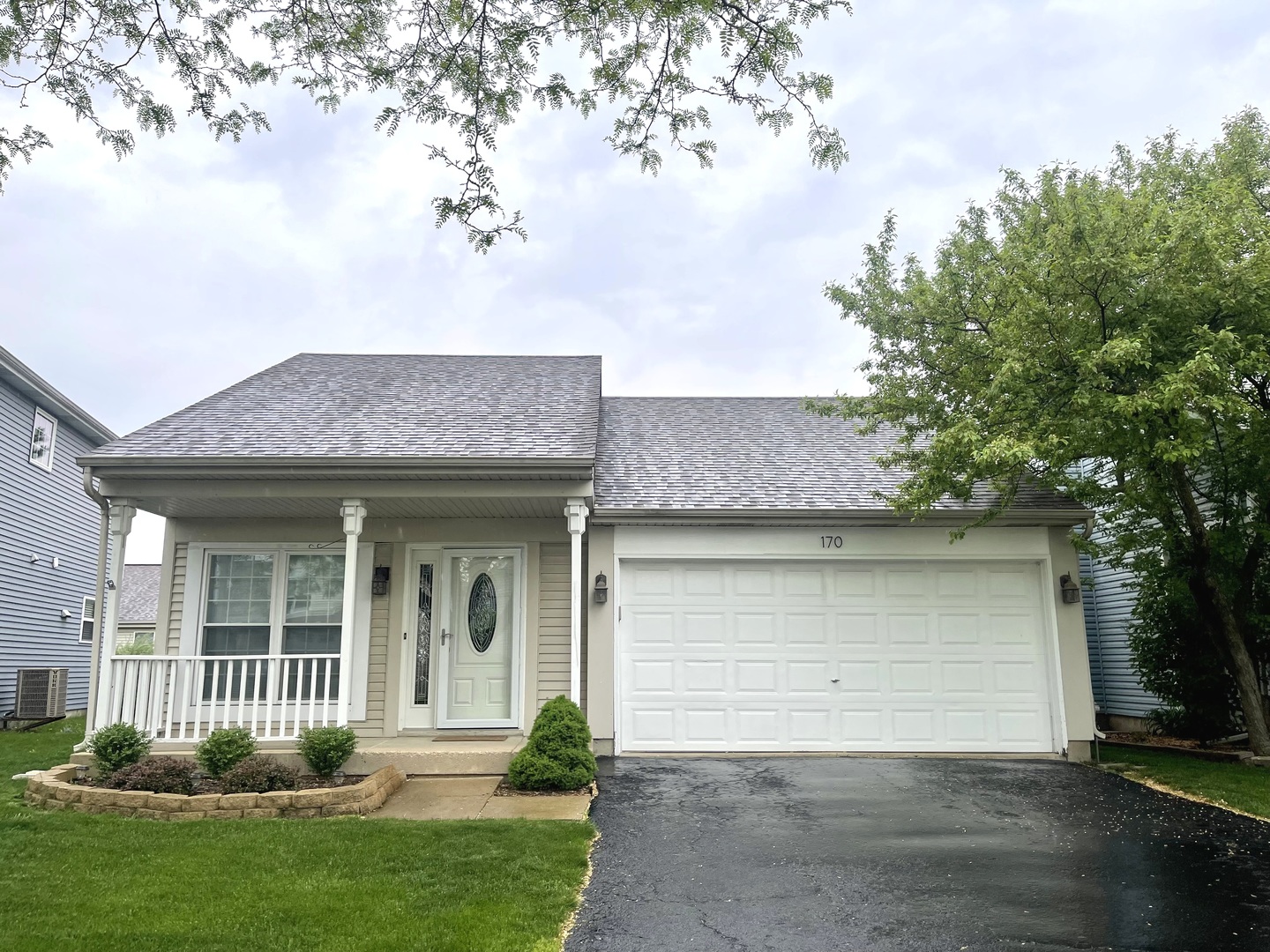 a front view of a house with a yard and garage