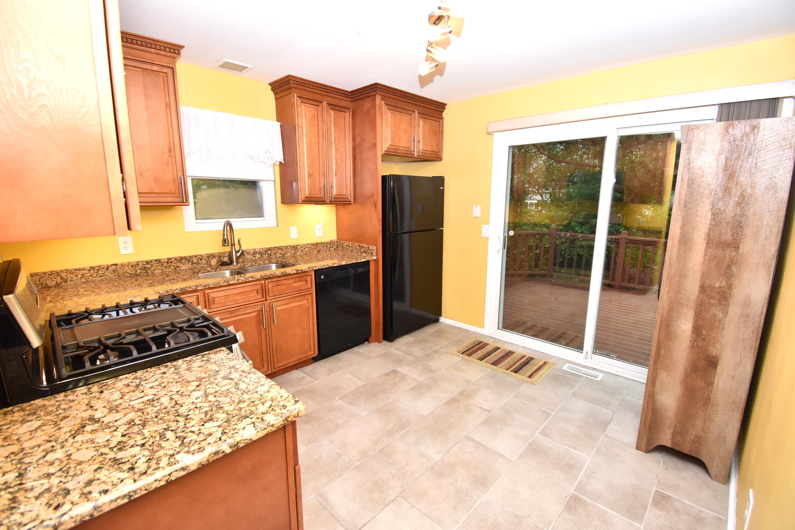 170 Hamlet Circle Montgomery, IL 60538 - Photo 7 of 13 a kitchen with stainless steel appliances granite countertop a stove a sink and a refrigerator