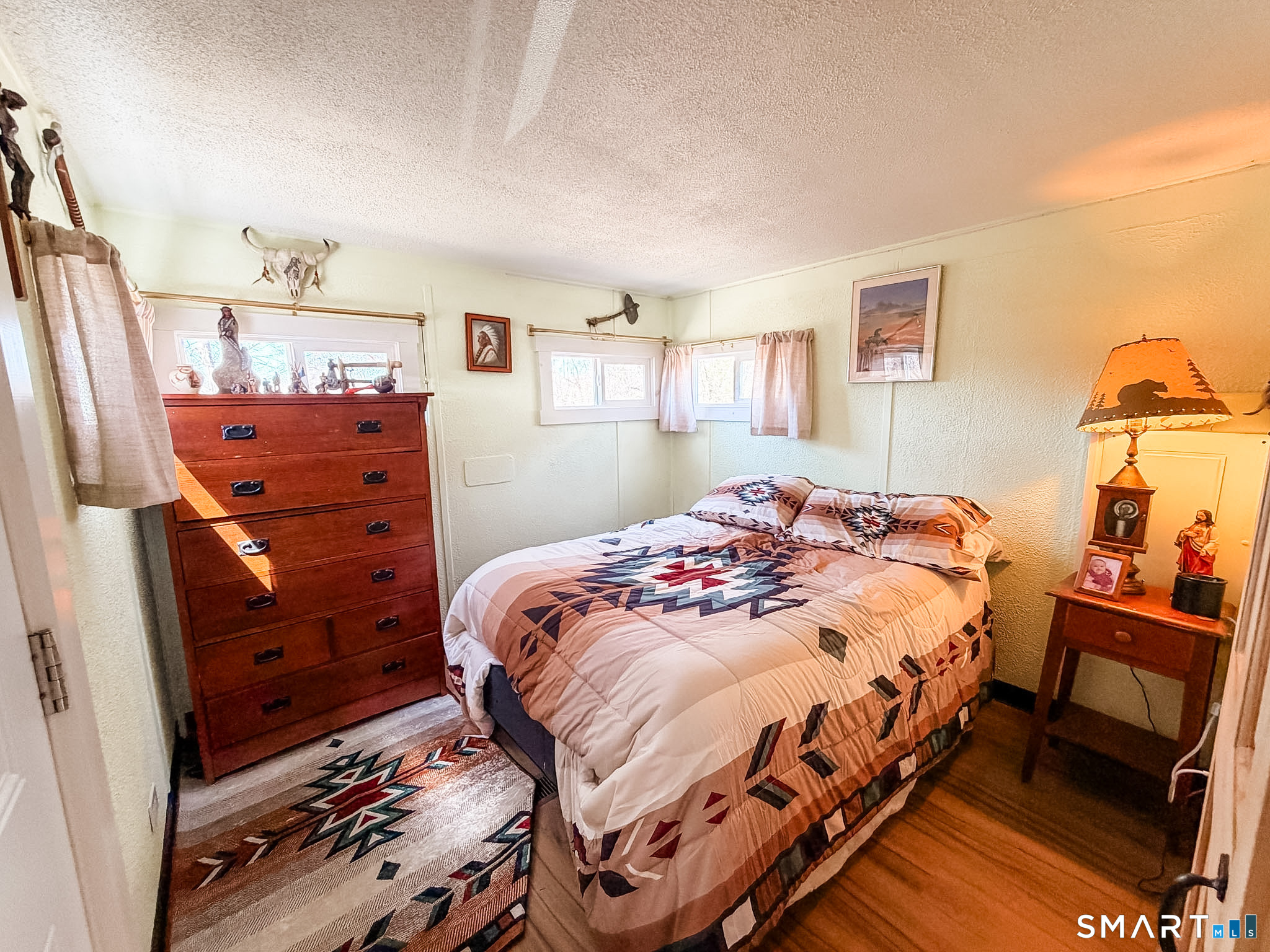 16 Conrad's Park Killingly, CT 06241 - Photo 5 of 12 a bedroom with a bed and wooden floor