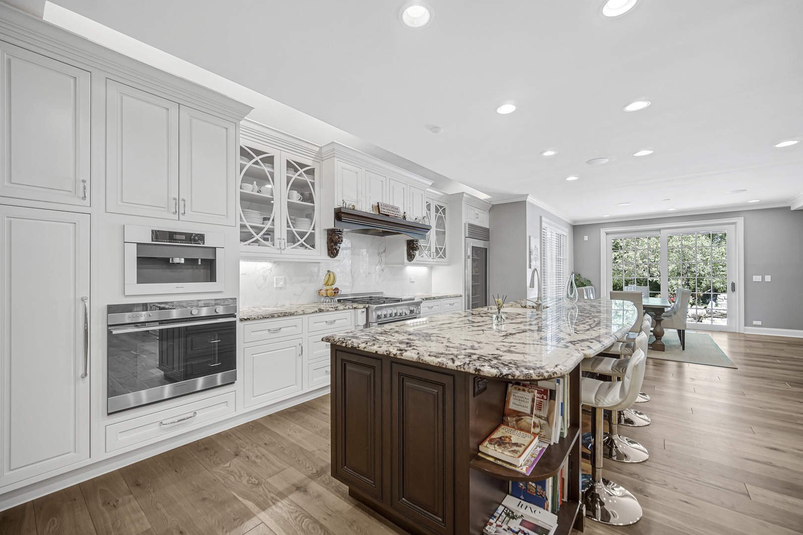 2800 Orange Brace Road Riverwoods, IL 60015 - Photo 13 of 41 a kitchen with stainless steel appliances granite countertop a stove top oven a sink dishwasher and a refrigerator with wooden floor