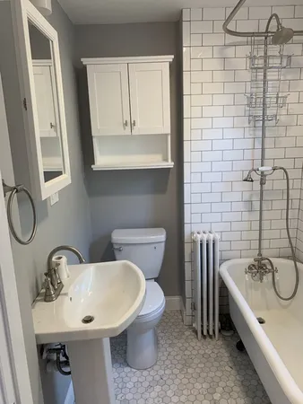 a bathroom with a sink a toilet and a mirror