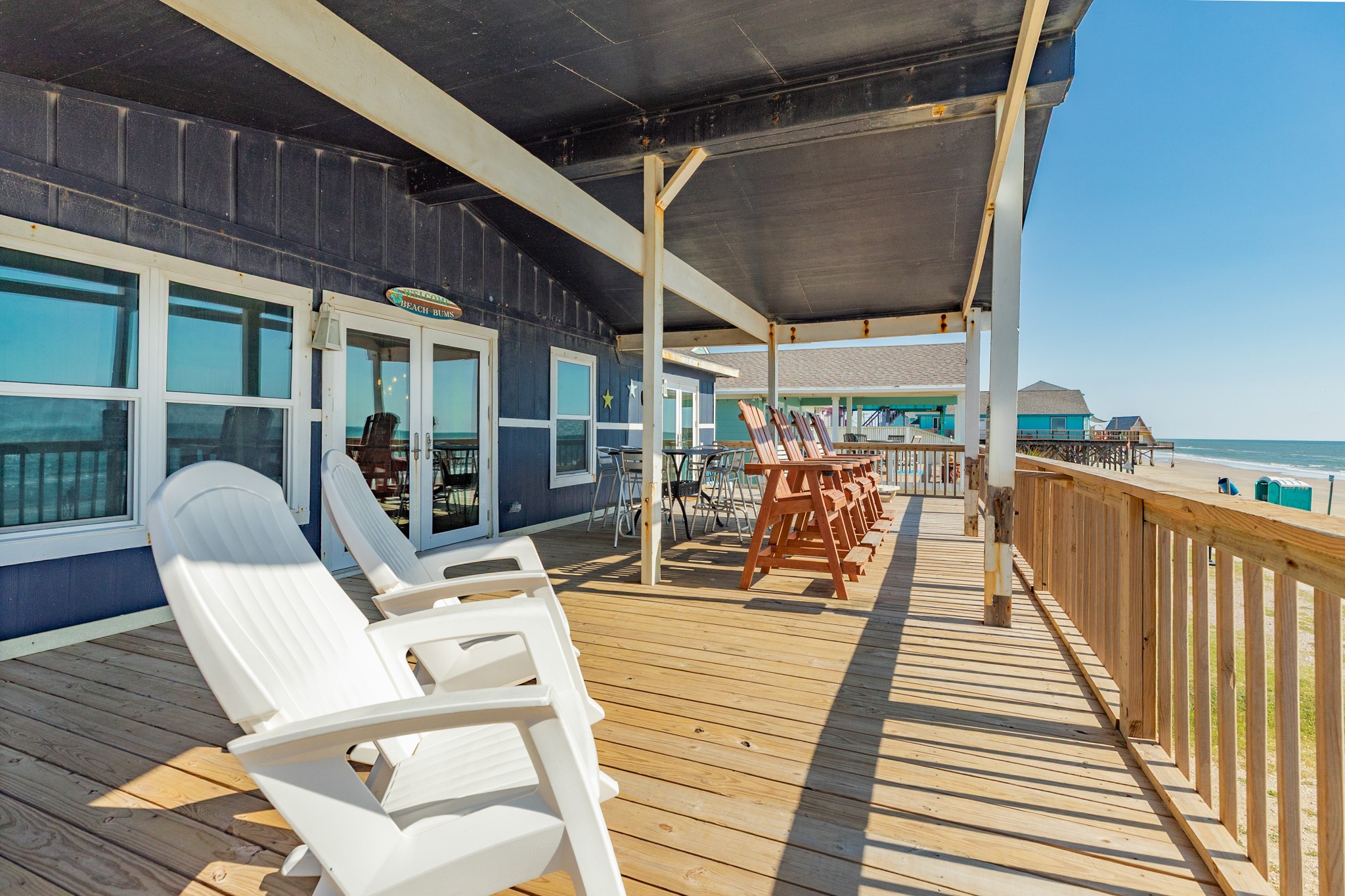 210 Beach Drive Surfside Beach, TX 77541 - Photo 13 of 33 Deck – Covered Lounge – Deep covered porch with multiple seating zones and bar-height chairs oriented to the Gulf, ideal for shade and sea breezes.