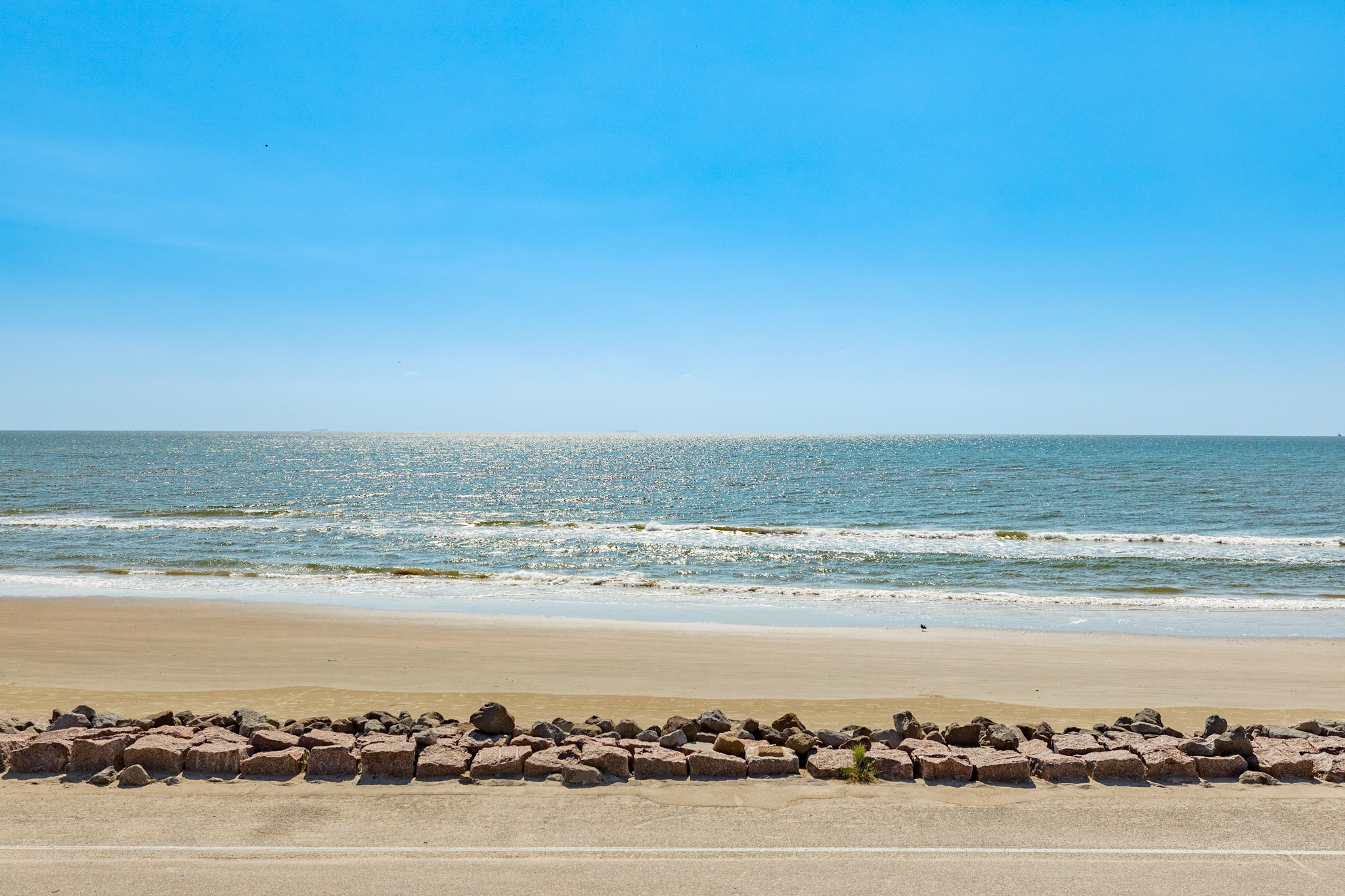 210 Beach Drive Surfside Beach, TX 77541 - Photo 33 of 33 Beach & Water View – Unobstructed Gulf panorama showcasing gentle waves and a wide sandy beach just across the beach drive.