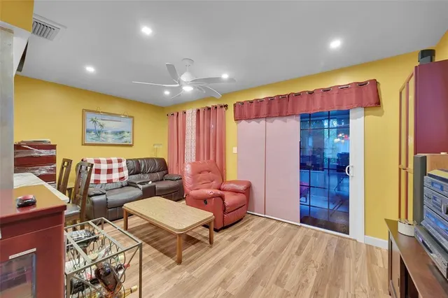 a living room with furniture a flat screen tv and a table